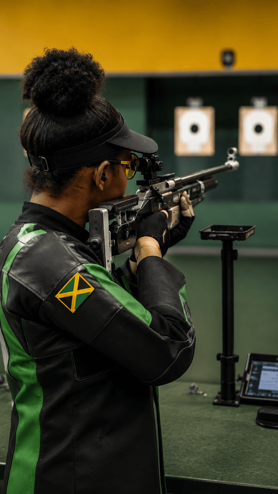 Coach guiding a young athlete through a shooting drill